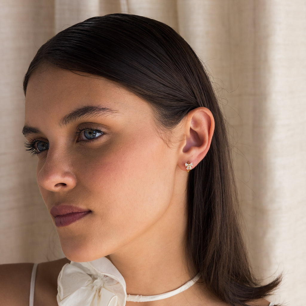 Little hoop earrings with a sparkly bow.