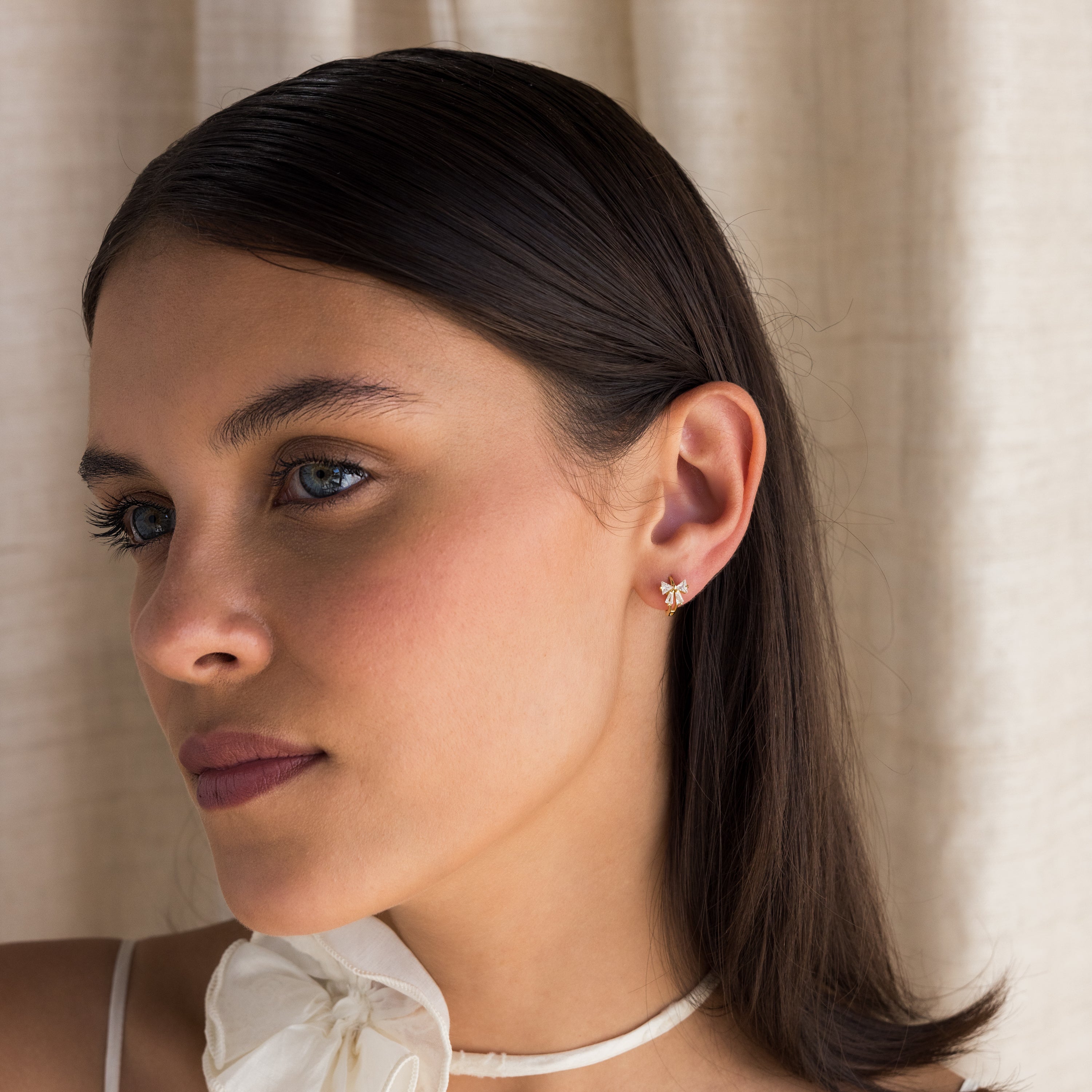 Little hoop earrings with a sparkly bow.