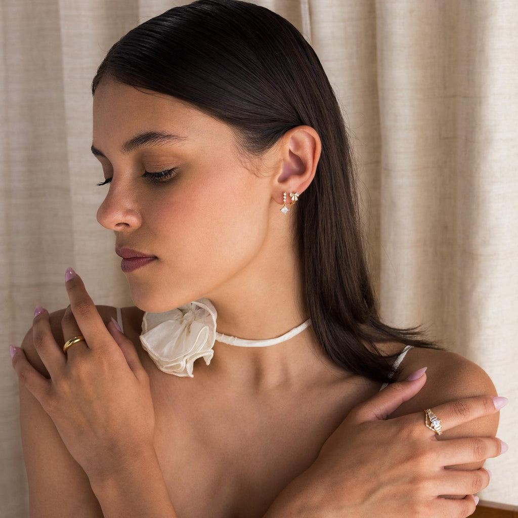 Little hoop earrings with a sparkly bow.