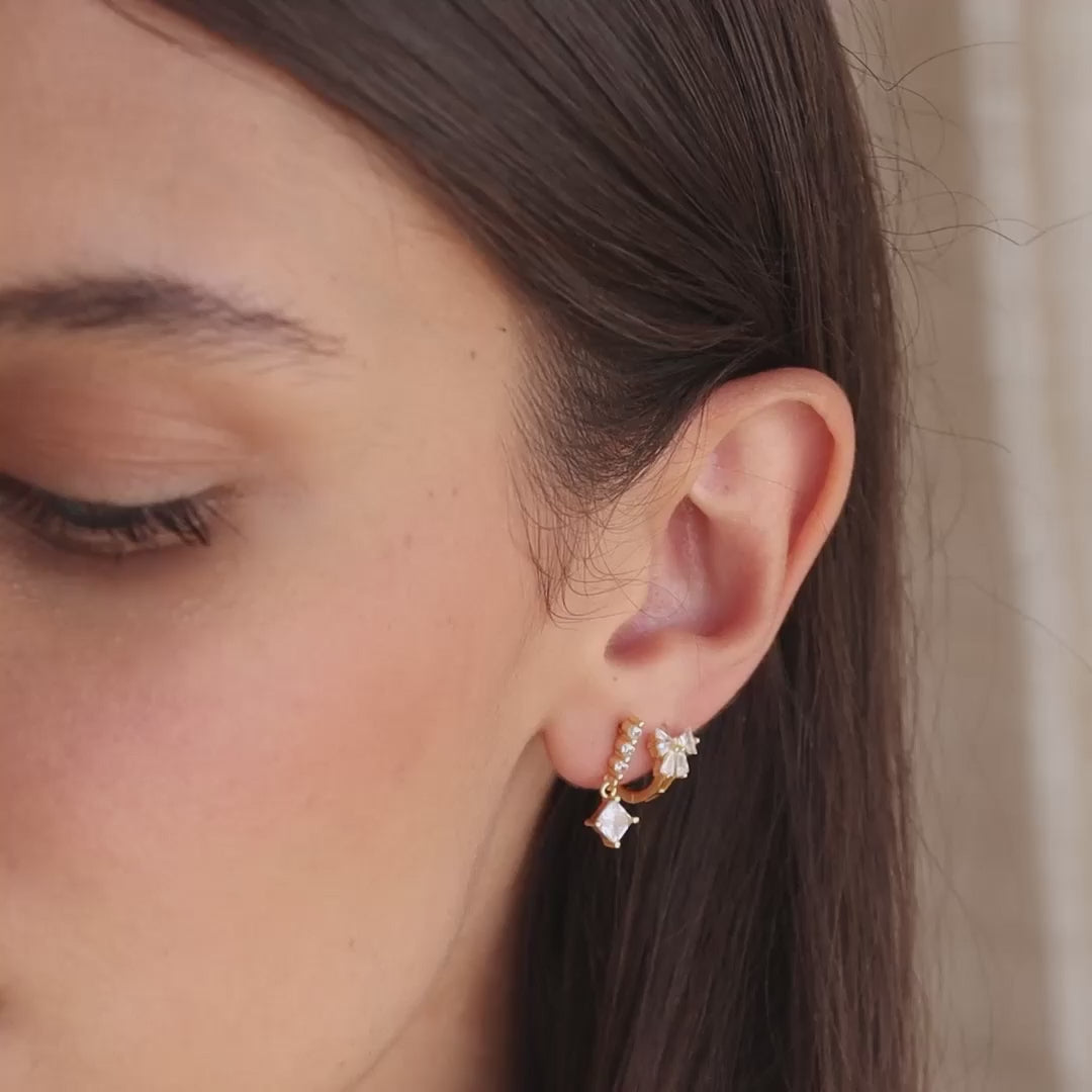 Little hoop earrings with a sparkly bow.